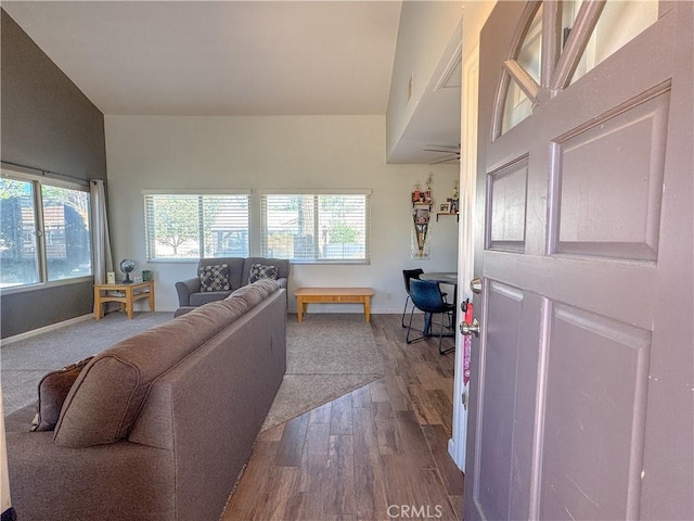 living area featuring baseboards and wood finished floors