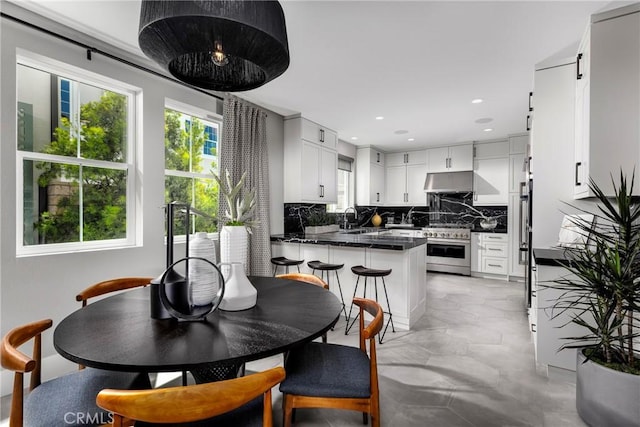 dining space with concrete flooring and recessed lighting