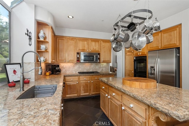 kitchen featuring light stone counters, open shelves, a sink, decorative backsplash, and black appliances