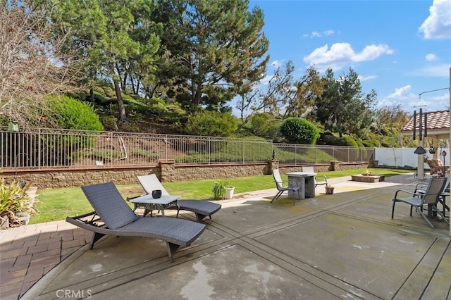 view of patio / terrace featuring outdoor dining area, a fenced backyard, and a fire pit