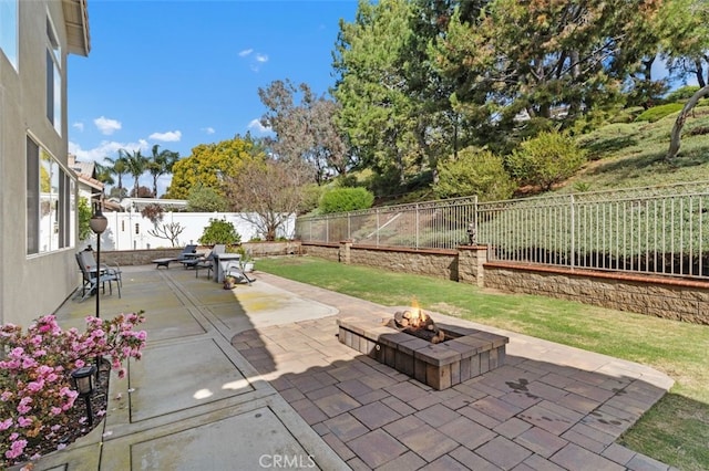 view of patio featuring a fire pit and a fenced backyard