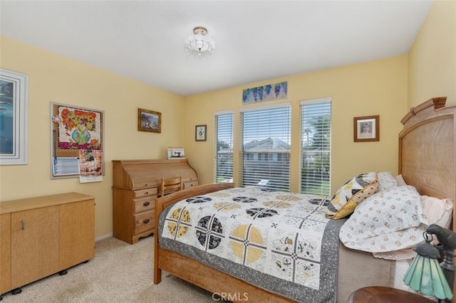 bedroom featuring baseboards and light colored carpet