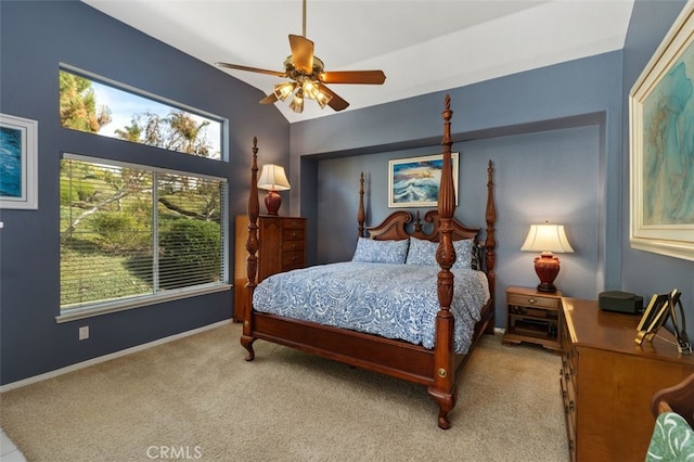 bedroom with light carpet, vaulted ceiling, baseboards, and ceiling fan