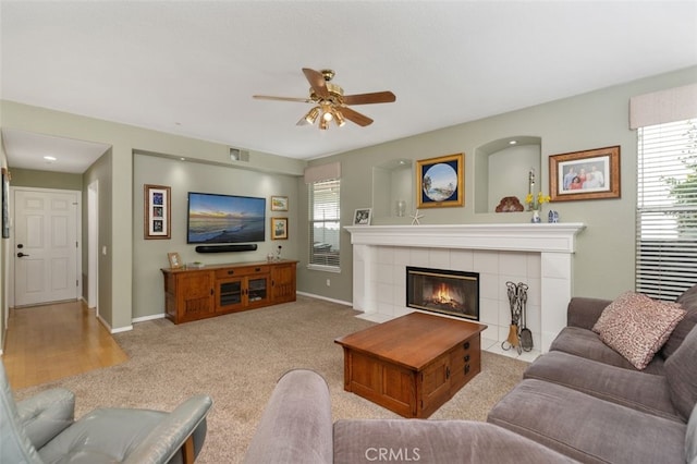 living room with light carpet, baseboards, a fireplace, and visible vents