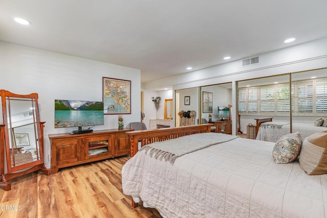 bedroom with light wood-type flooring, visible vents, and recessed lighting