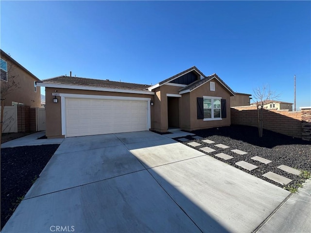 ranch-style house featuring driveway, a garage, fence, and stucco siding