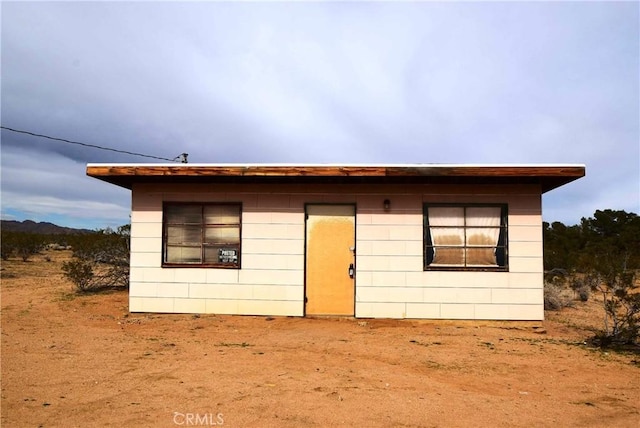 view of front of house featuring concrete block siding