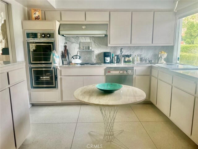 300 S Patencio Rd, Palm Springs, CA 92262 - kitchen featuring dishwasher, light countertops, ventilation hood, and double oven