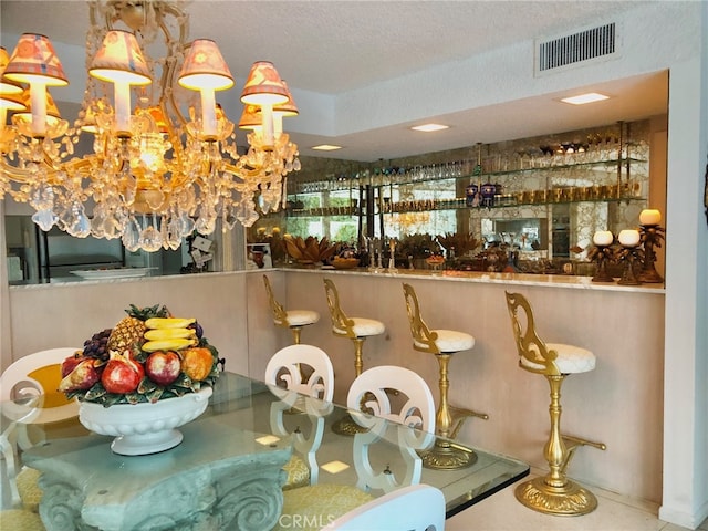 300 S Patencio Rd, Palm Springs, CA 92262 - dining space with a textured ceiling, a community bar, and a chandelier