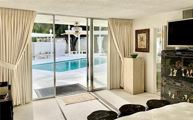 300 S Patencio Rd, Palm Springs, CA 92262 - carpeted living area featuring a wall of windows and a textured ceiling