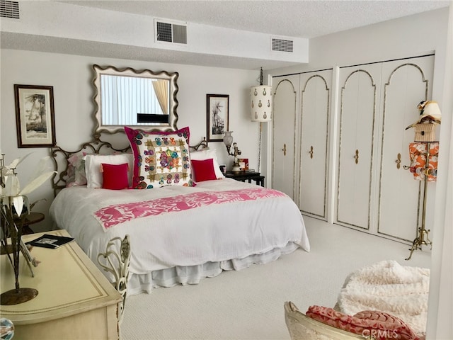 300 S Patencio Rd, Palm Springs, CA 92262 - carpeted bedroom featuring two closets and a textured ceiling