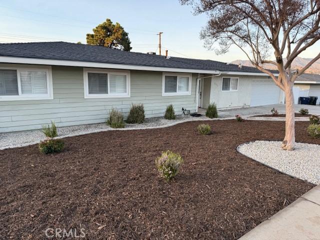 ranch-style home with concrete driveway and an attached garage