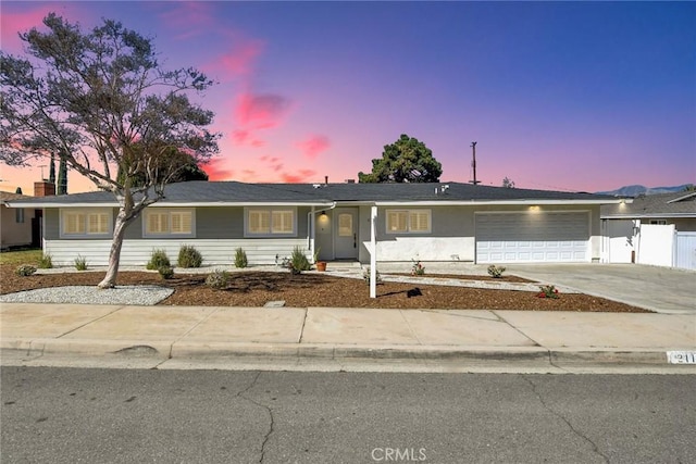 ranch-style home with a garage and driveway