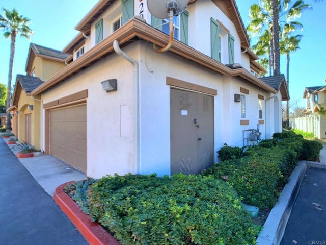 view of home's exterior with a garage and stucco siding