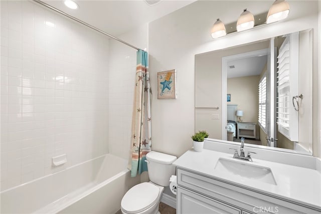 full bathroom featuring shower / tub combo with curtain, vanity, and toilet