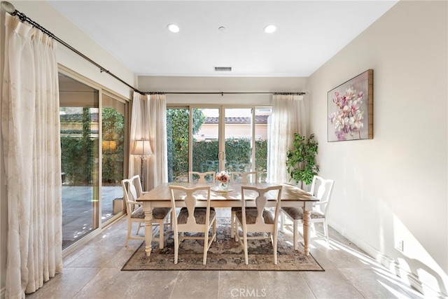 unfurnished dining area featuring baseboards, visible vents, and recessed lighting