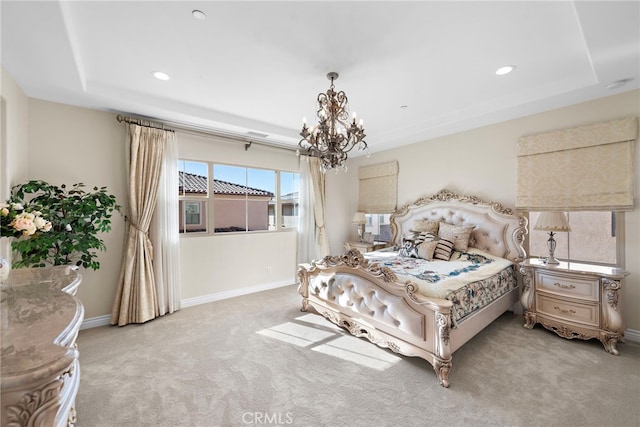 bedroom featuring a tray ceiling, light carpet, a notable chandelier, and baseboards