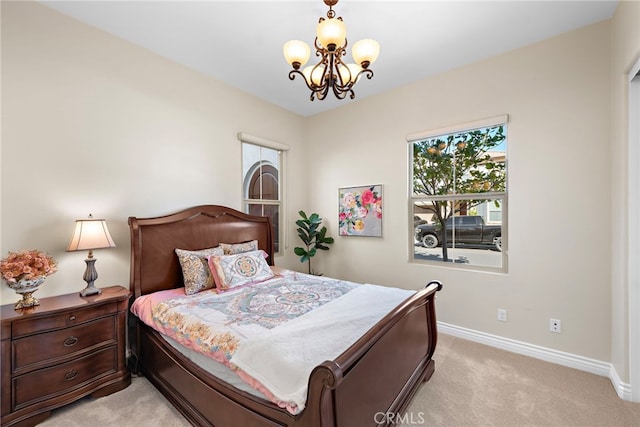 bedroom featuring multiple windows, light carpet, baseboards, and an inviting chandelier