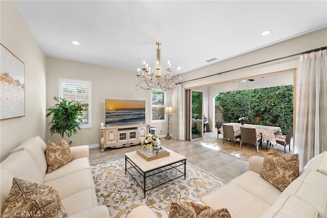 living room featuring light tile patterned flooring, visible vents, recessed lighting, and an inviting chandelier