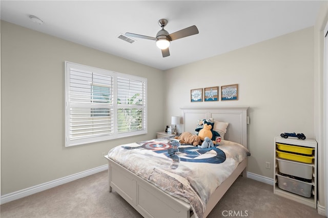 bedroom featuring a ceiling fan, light colored carpet, visible vents, and baseboards