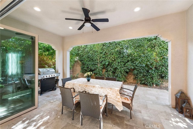 view of patio / terrace featuring a grill, outdoor dining area, and a ceiling fan