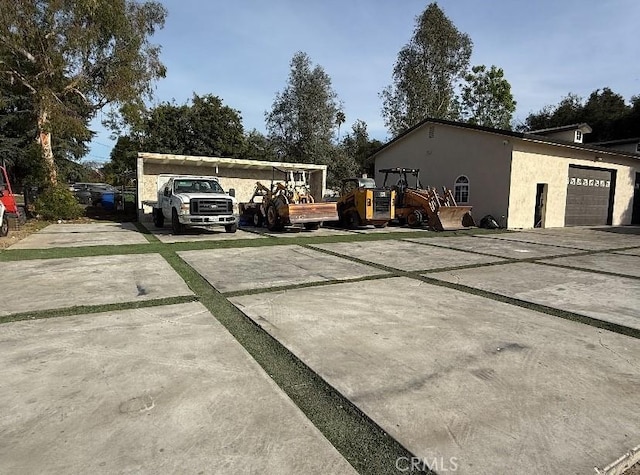 exterior space with concrete driveway and stucco siding