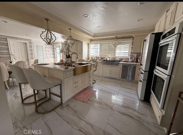 kitchen featuring a kitchen island, ornamental molding, decorative light fixtures, marble finish floor, and a sink