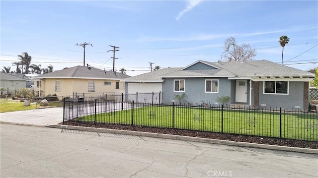 view of front of property featuring a fenced front yard, a front lawn, concrete driveway, and stucco siding