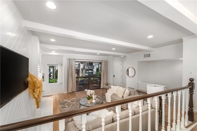 living room with light wood finished floors, beamed ceiling, and recessed lighting