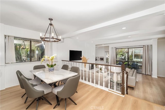 dining area with a notable chandelier, beamed ceiling, recessed lighting, and light wood-style floors