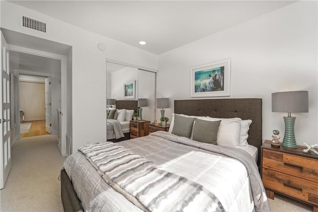 bedroom featuring light colored carpet, a closet, visible vents, and recessed lighting