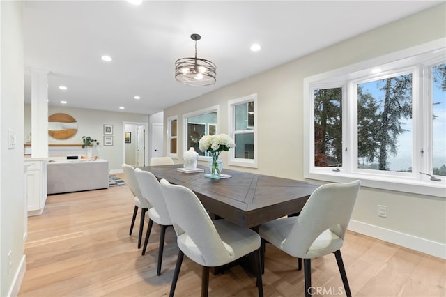 dining area with baseboards, light wood-style flooring, and recessed lighting