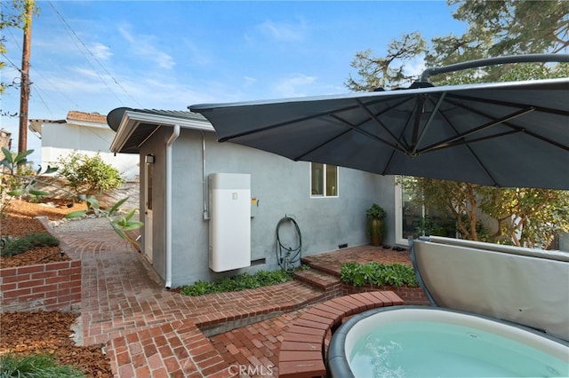 exterior space with a patio and stucco siding