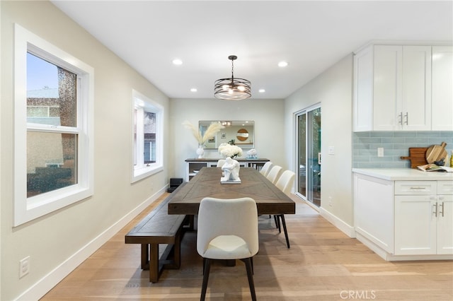 dining space with light wood-type flooring, baseboards, and recessed lighting