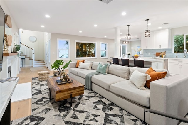 living room with visible vents, stairway, and recessed lighting