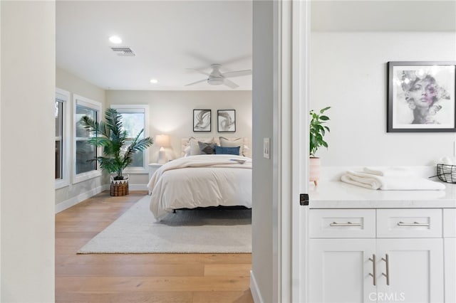 bedroom with ceiling fan, recessed lighting, visible vents, baseboards, and light wood finished floors