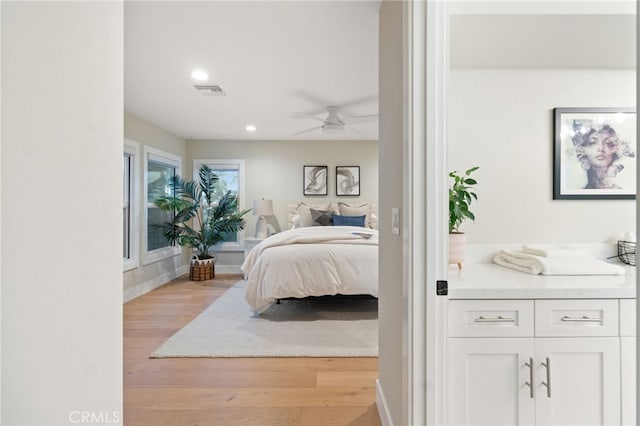 bedroom with recessed lighting, visible vents, ceiling fan, light wood-type flooring, and baseboards