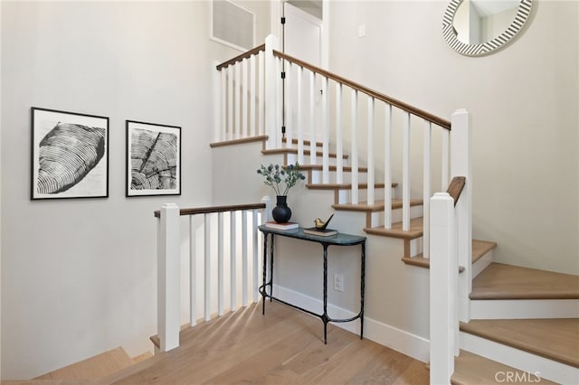 stairway featuring visible vents and wood finished floors