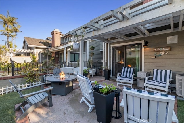 view of patio featuring fence, a fire pit, and a pergola