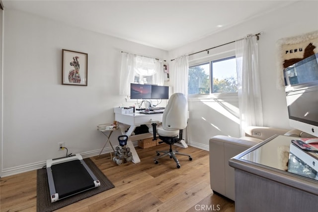 office space with baseboards and wood finished floors