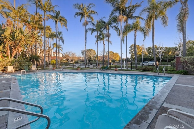 community pool featuring fence