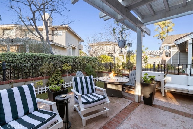 view of patio featuring an outdoor fire pit and fence