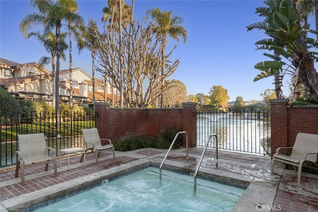 view of pool featuring a hot tub and fence