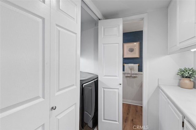 interior space with laundry area, wood finished floors, and washer / dryer