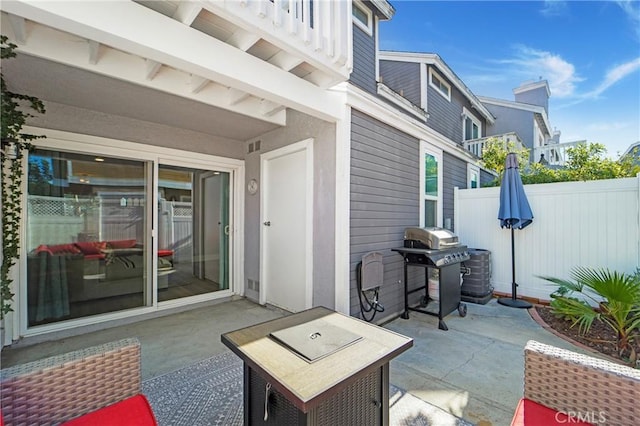 view of patio with central air condition unit, fence, and grilling area