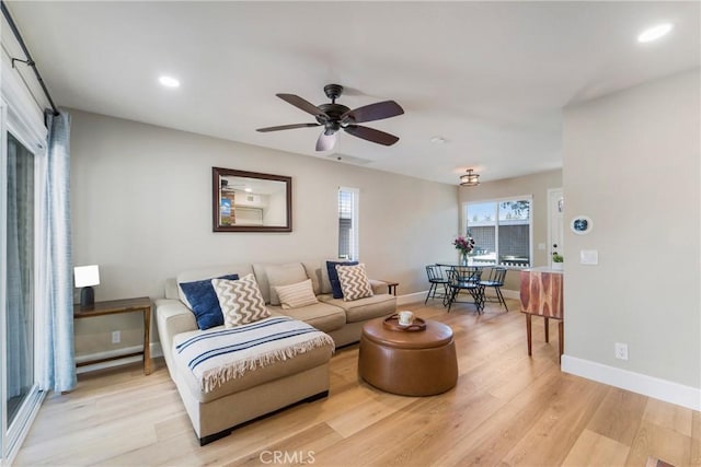 living area with light wood-style floors, recessed lighting, baseboards, and a ceiling fan