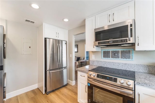 kitchen with recessed lighting, visible vents, appliances with stainless steel finishes, light wood-style floors, and white cabinetry