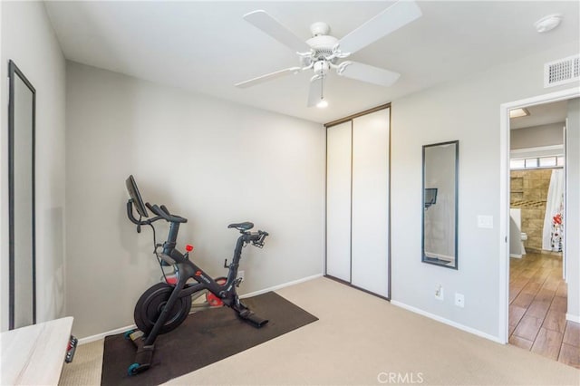 workout area featuring carpet, baseboards, visible vents, and a ceiling fan