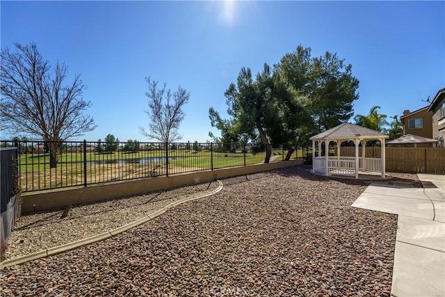 view of yard with fence and a gazebo