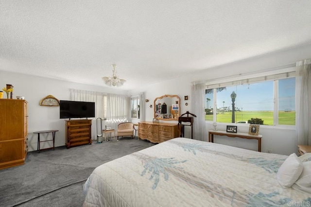 bedroom with carpet floors, a chandelier, and a textured ceiling